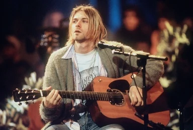 Kurt Cobain with his iconic 90's grunge look.